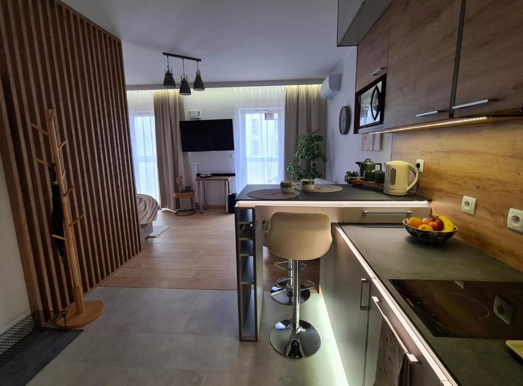 a kitchen with a counter and a kitchen island in a room at Malta Delux Apartment, free parking, self check-in 24h in Poznań