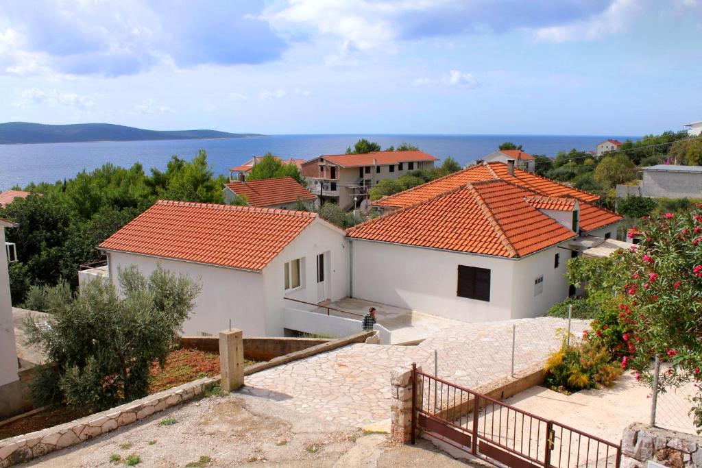 a view of the houses and the water at Apartments and rooms with parking space Zavala, Hvar - 128 in Jelsa