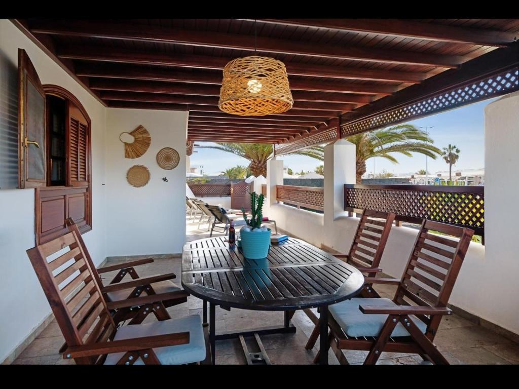a table and chairs on a patio with a ceiling at VILLA HELEN in Playa Blanca