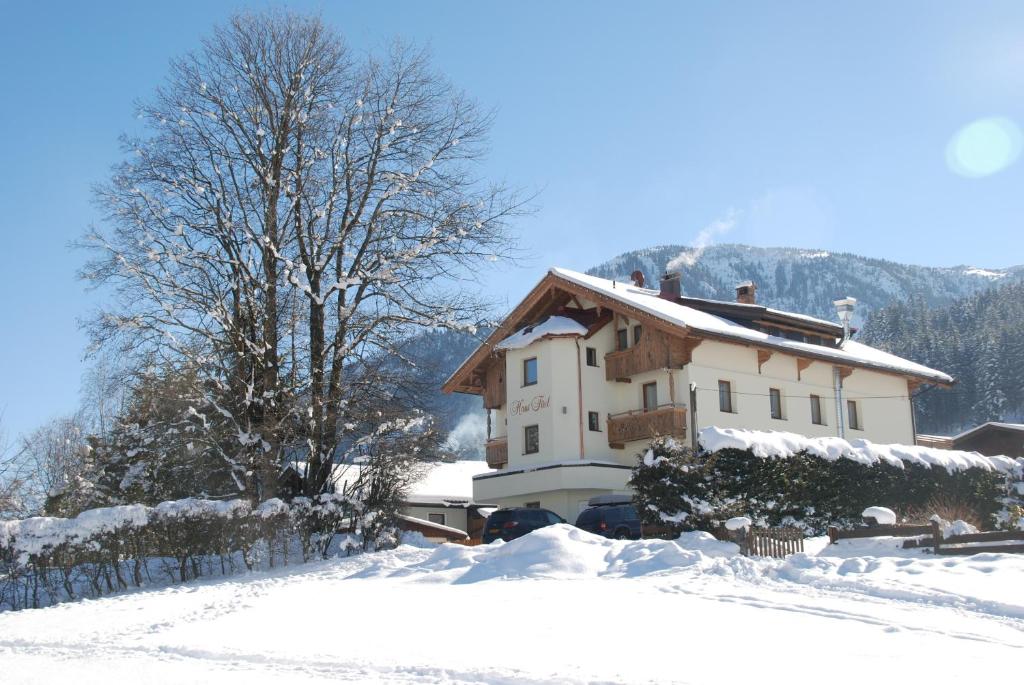 a house with snow on the ground in front of it at Haus Tirol in Brixen im Thale
