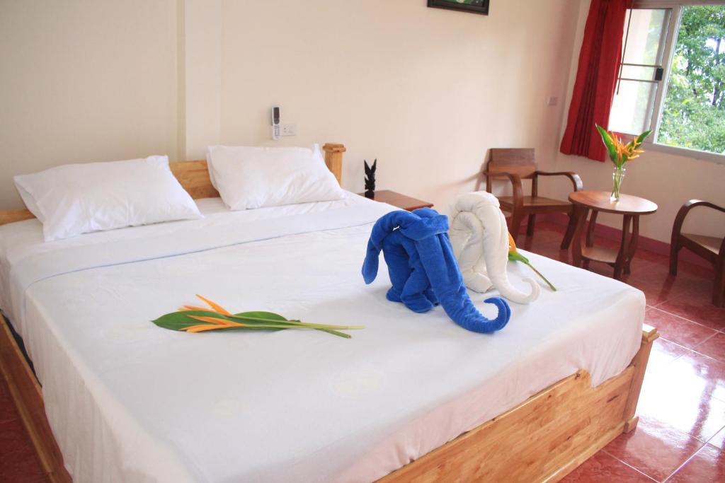 Postel nebo postele na pokoji v ubytování Dragon Hut Resort