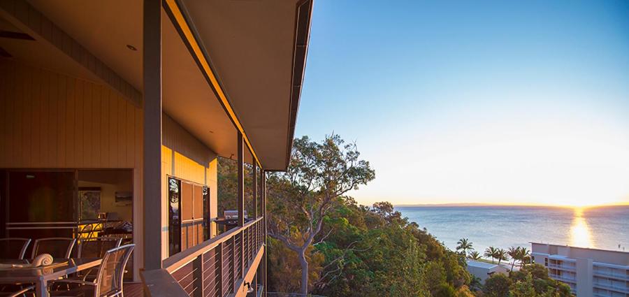 a balcony of a house with a view of the ocean at Tangalooma Holiday House in Tangalooma