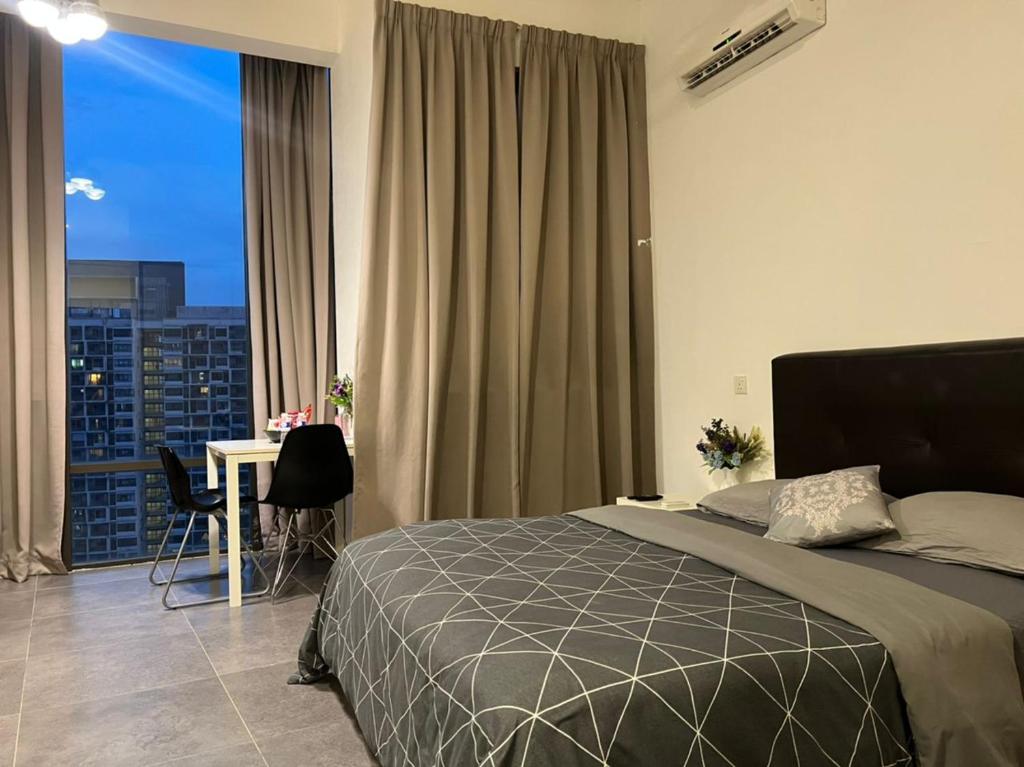 a bedroom with a bed and a desk and a window at EmpiStudio @ Empire Damansara in Petaling Jaya