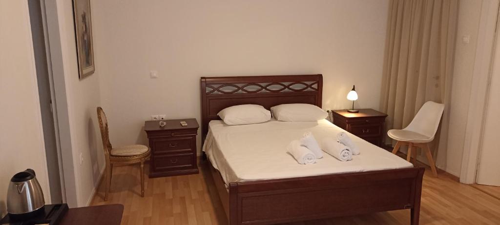 a bedroom with a bed with two pillows on it at Amerikis Street 1 bedroom apartment in Athens
