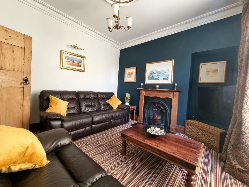 a living room with a couch and a fireplace at 2 Mill Street in Penrith