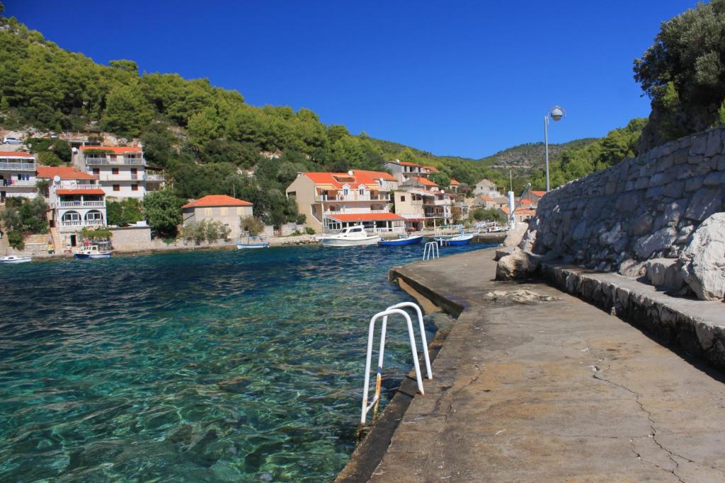 a view of a river with houses and buildings at Apartments by the sea Grscica, Korcula - 4487 in Prizba