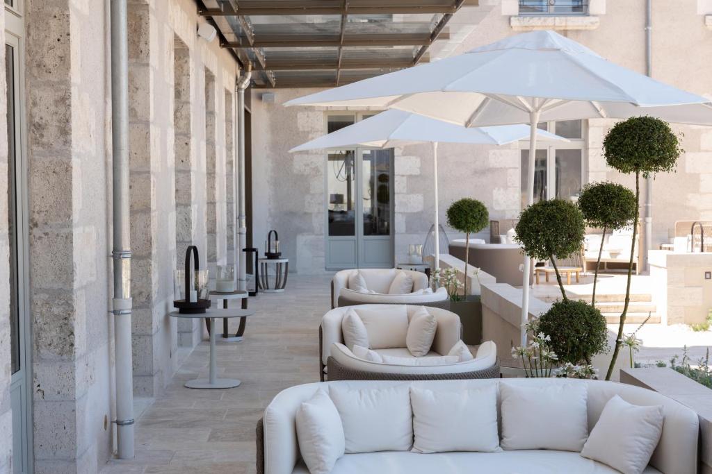 a lobby with two white couches and an umbrella at Fleur de Loire in Blois