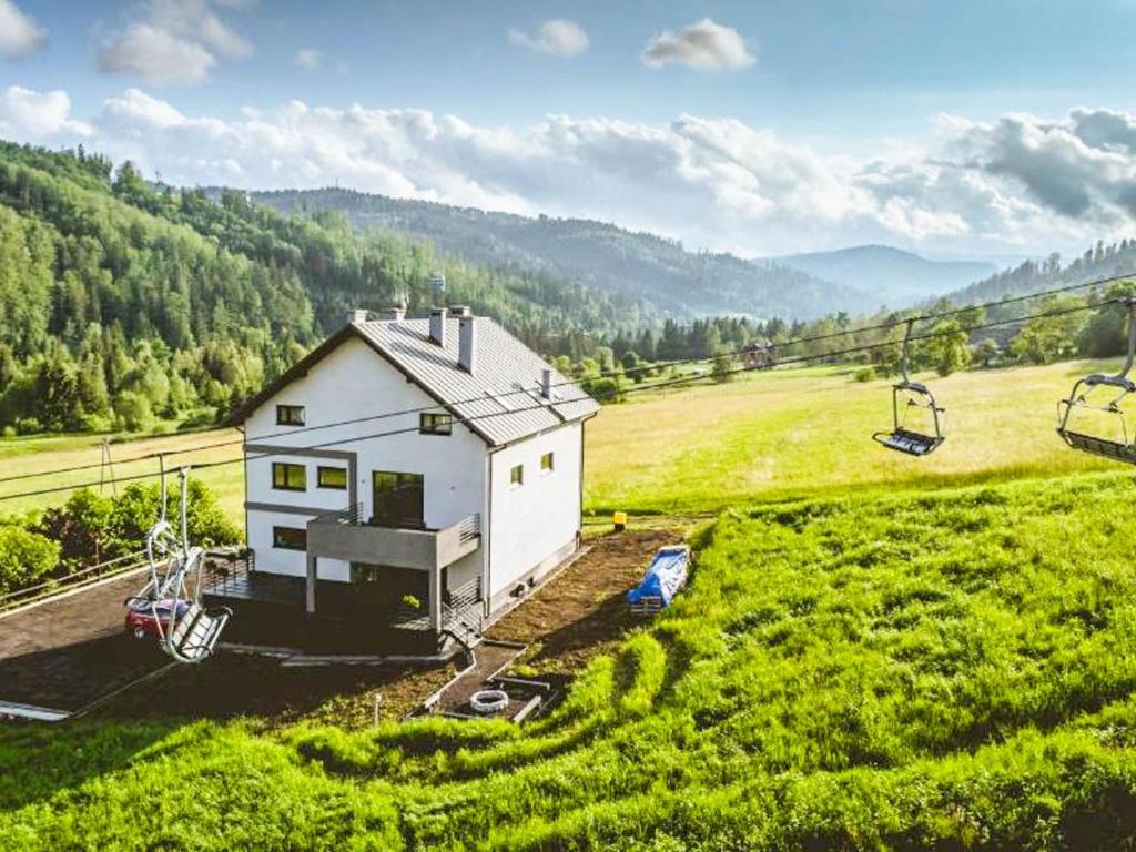 an aerial view of a house in a green field at Willa Monte in Wisła