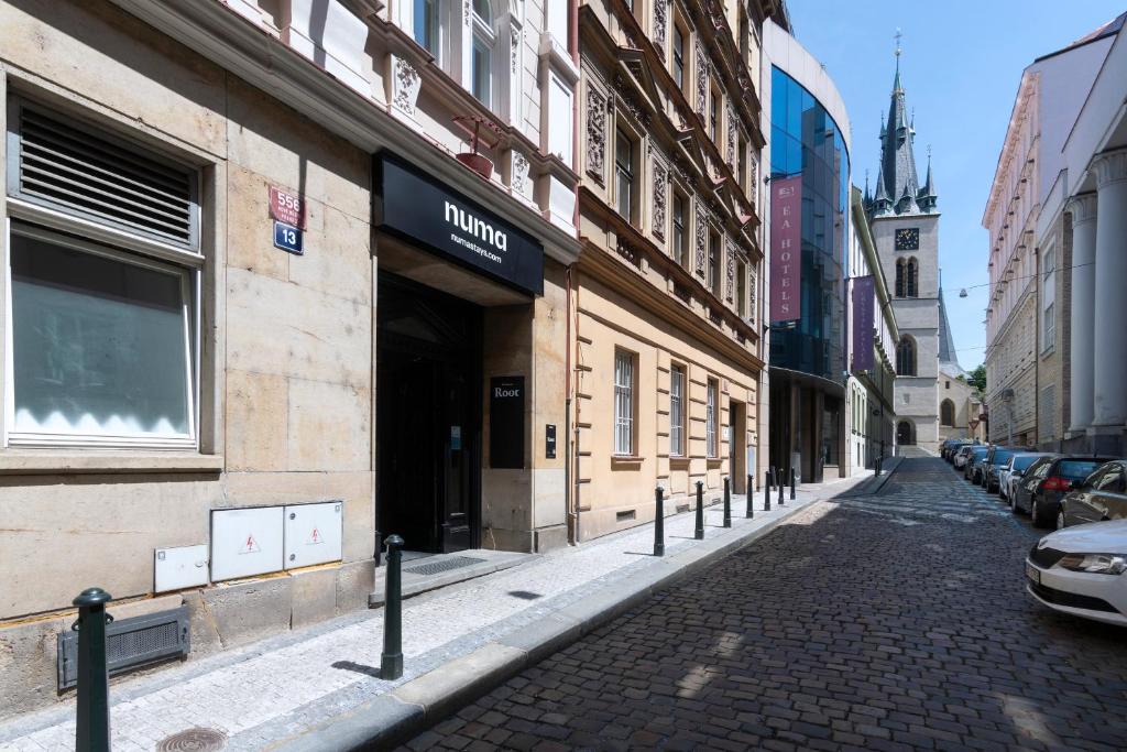 una strada di ciottoli in una città con edifici di numa l Root Rooms & Apartments a Praga