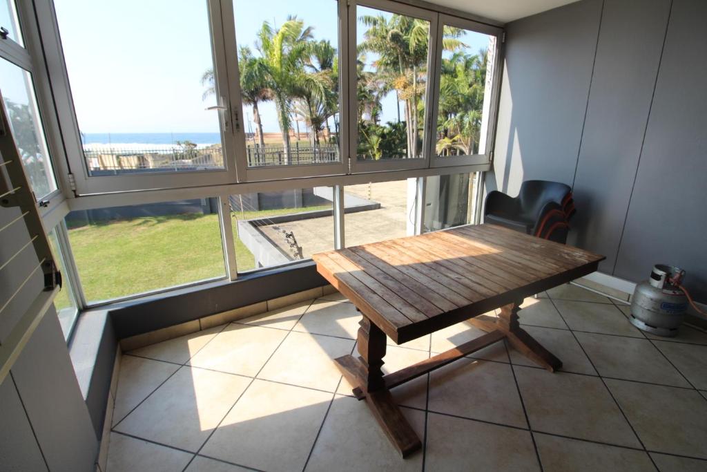 a table in a room with a view of the ocean at Boulevard 114 in Margate