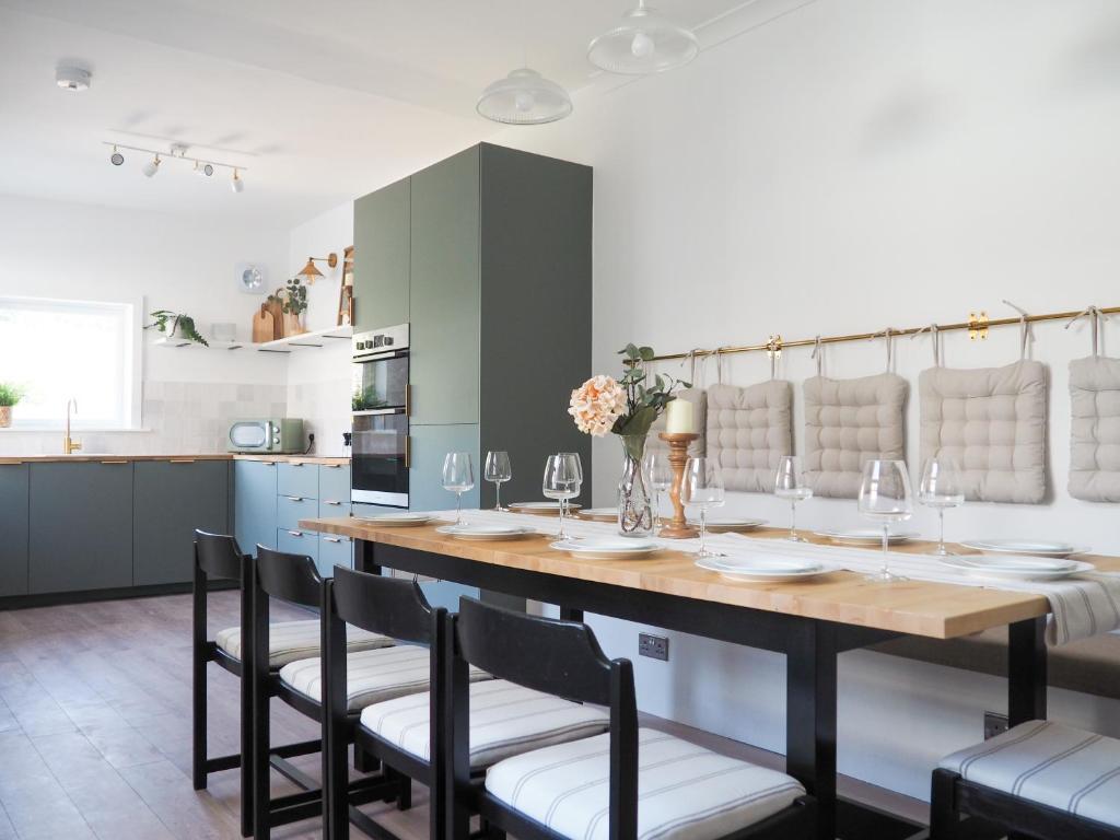 a kitchen with a large wooden table and chairs at Coorie Away - Kirkcudbright in Kirkcudbright