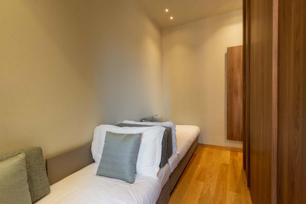 a room with a white couch with two pillows on it at ELICAL Exclusive Private Suites in Rome