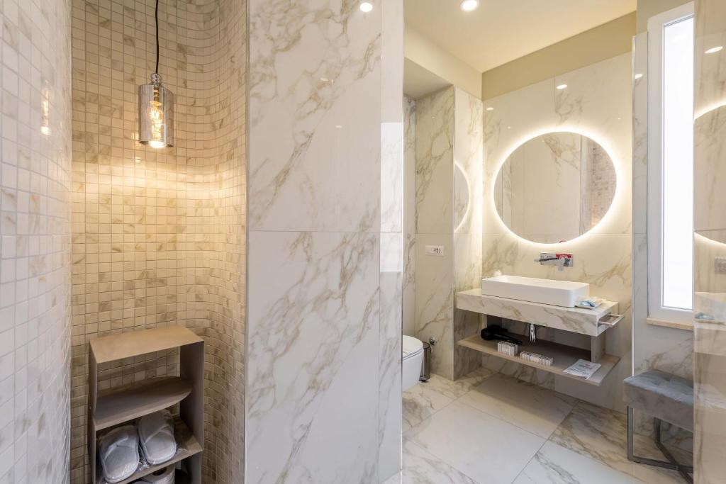 a bathroom with a sink and a mirror at ELICAL Exclusive Private Suites in Rome