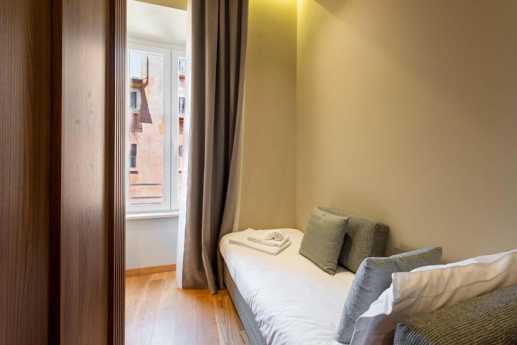 a small room with a bed and a window at ELICAL Exclusive Private Suites in Rome