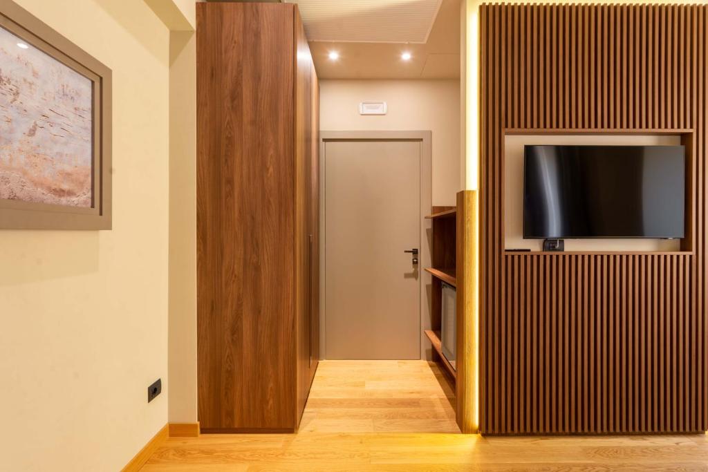 a hallway with a flat screen tv on a wall at ELICAL Exclusive Private Suites in Rome