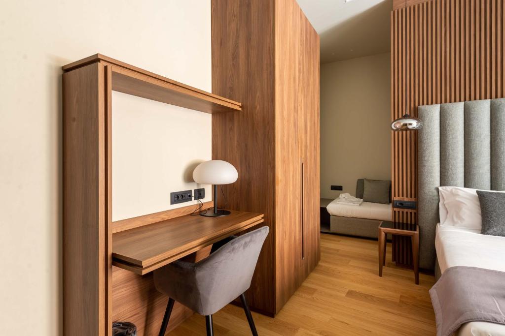 a bedroom with a desk with a mirror and a bed at ELICAL Exclusive Private Suites in Rome