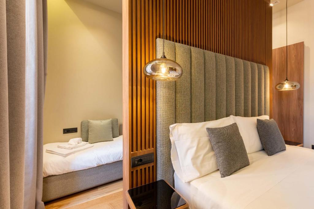 a hotel room with two beds and a mirror at ELICAL Exclusive Private Suites in Rome