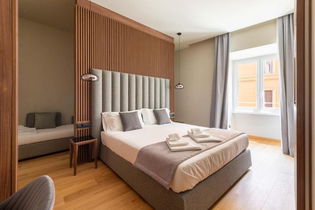 a bedroom with a large bed and a window at ELICAL Exclusive Private Suites in Rome