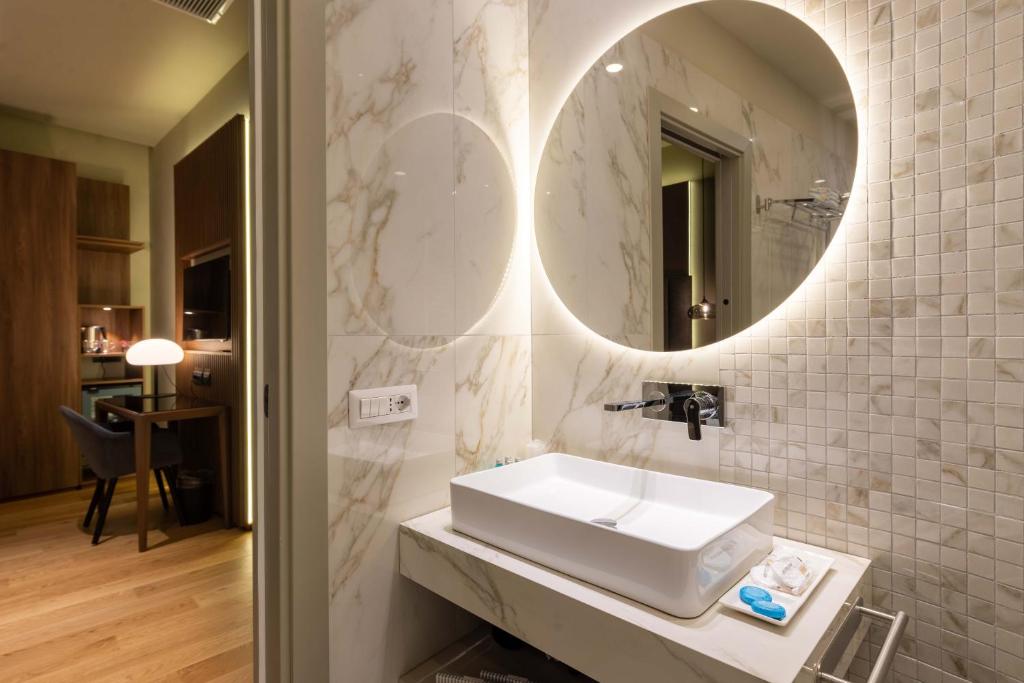 a bathroom with a sink and a mirror at ELICAL Exclusive Private Suites in Rome