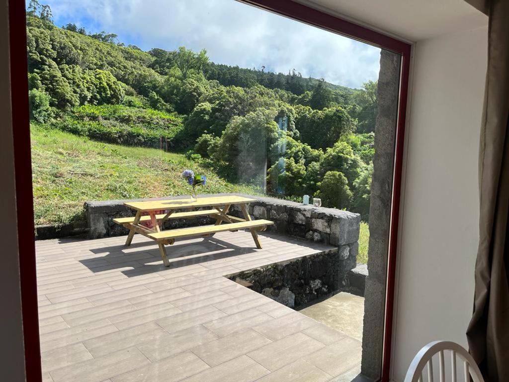 a view from a window of a patio with a picnic table at Casa de Foros in Ribeirinha