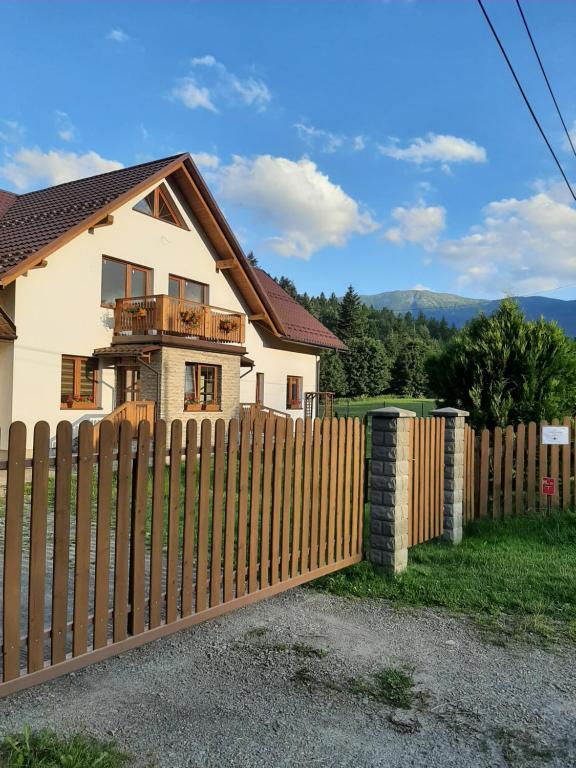 a wooden fence in front of a house at Dom Dobre Miejsce in Zawoja