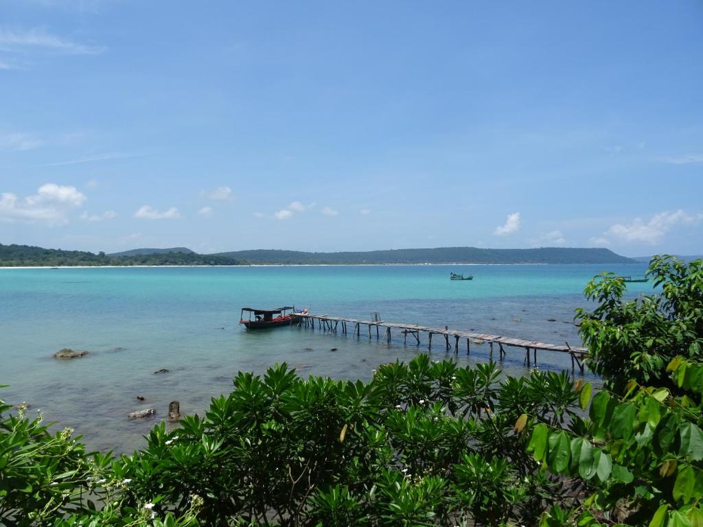 a beach with a dock in the water at Zest'house in Koh Rong Island