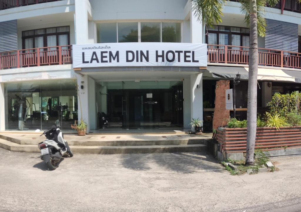 a motorcycle parked in front of a hotel at Laemdin Hotel in Koh Samui 