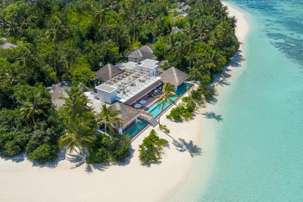 an aerial view of a resort on a beach at Raffles Maldives Meradhoo in Gaafu Alifu Atoll
