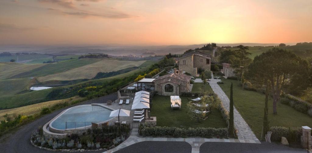 an aerial view of a mansion with a swimming pool at Capanna Suites in Montalcino