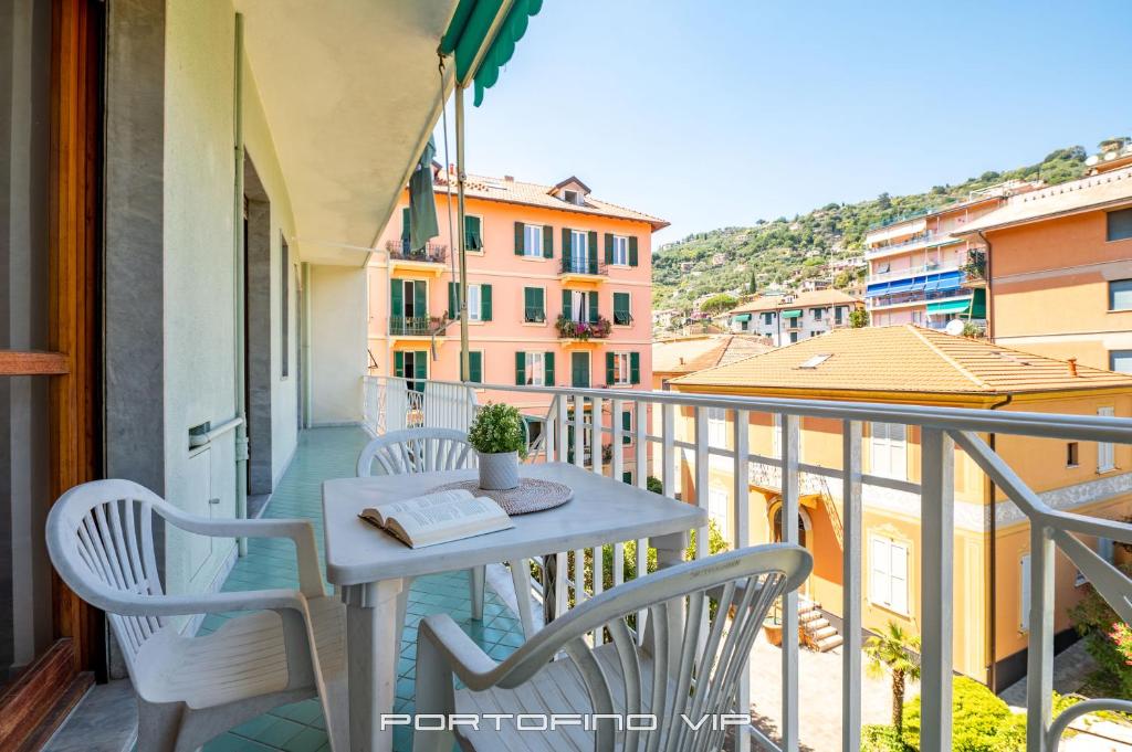 una mesa y sillas en un balcón con vistas en Casa Elisa by PortofinoVip, en Santa Margherita Ligure