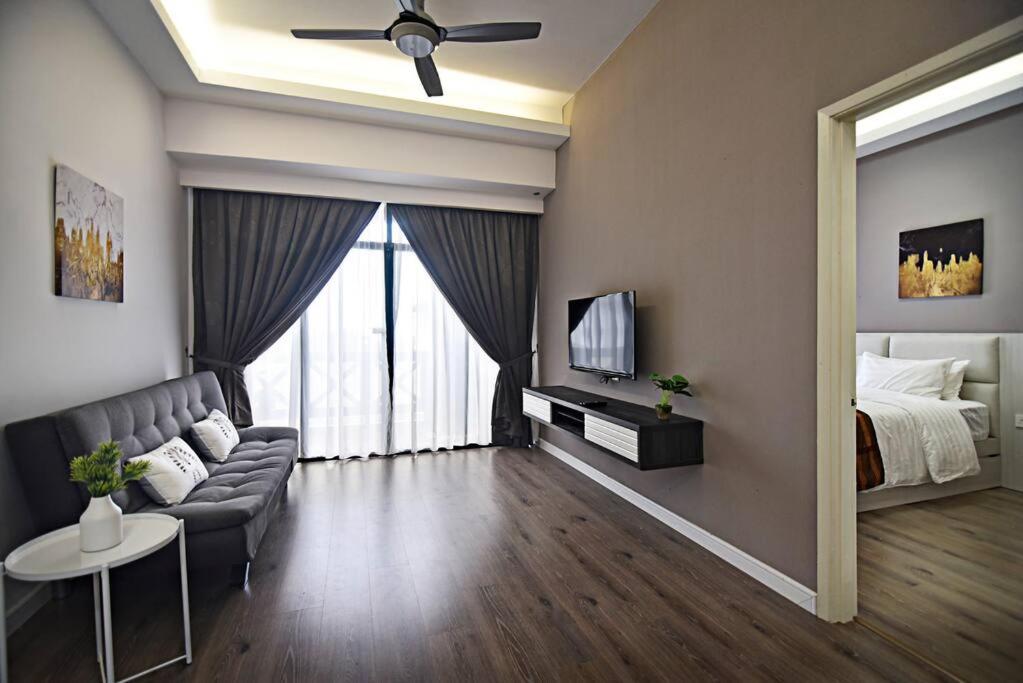 a living room with a couch and a bed at Instay Costa Mahkota Next to Mahkota Parade in Malacca