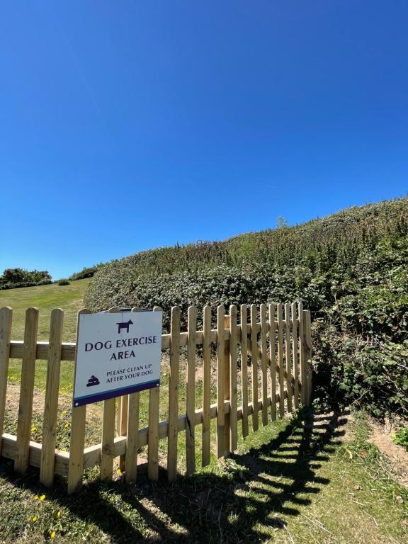 a sign on a fence in front of a field at Croyde Bay Hotel or Self Catering in Croyde