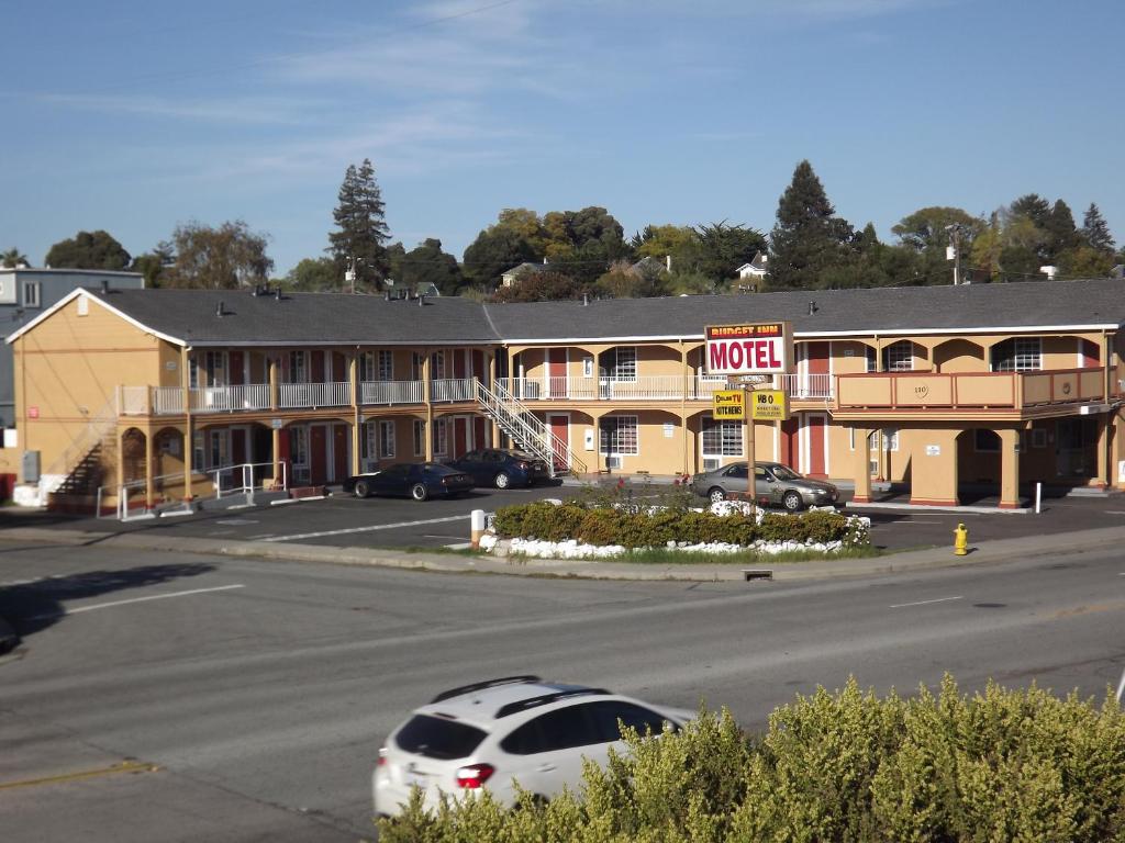 a hotel with a car parked in a parking lot at Drift Inn, LLC in Santa Cruz