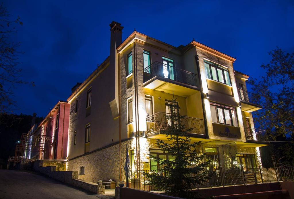 a large building at night with its lights on at Vaela Hotel Cultural Resort in Elatochori