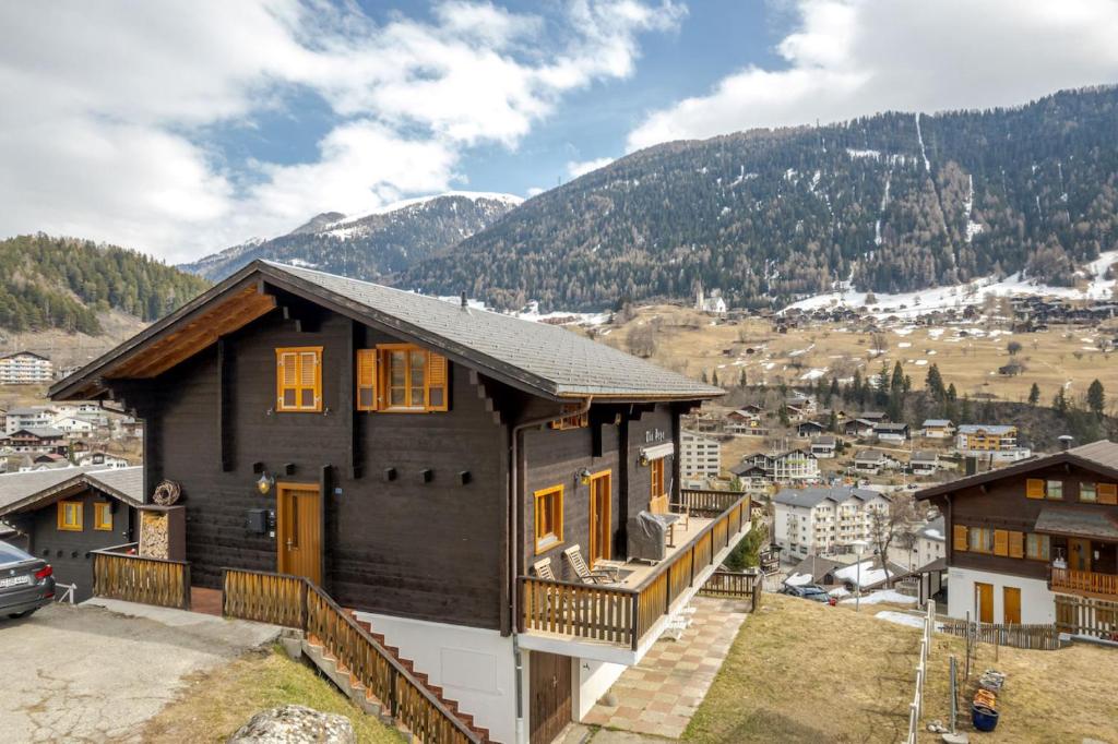 a house on a hill with mountains in the background at Tio Pepe OG in Fiesch