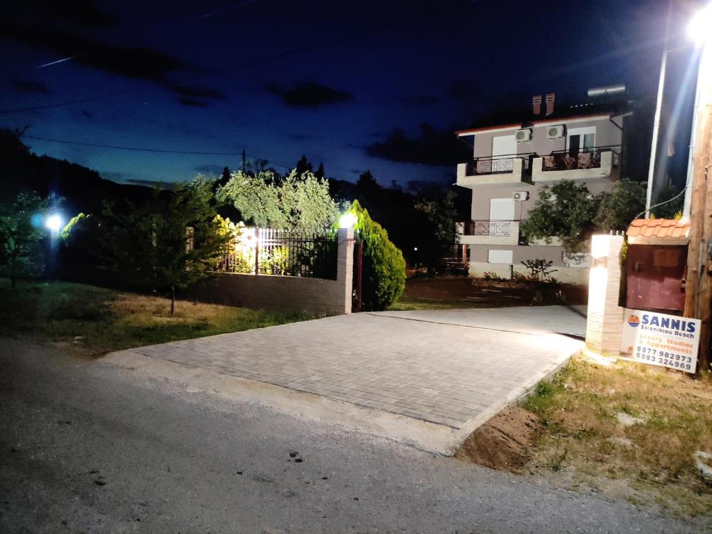 un vialetto di fronte a una casa di notte di Sanni Beach Salonikiou a Akti Salonikiou
