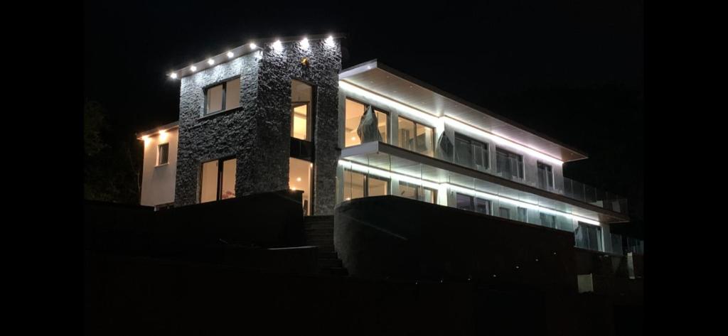 a building with lights on it at night at The Wylies in Dunmurry