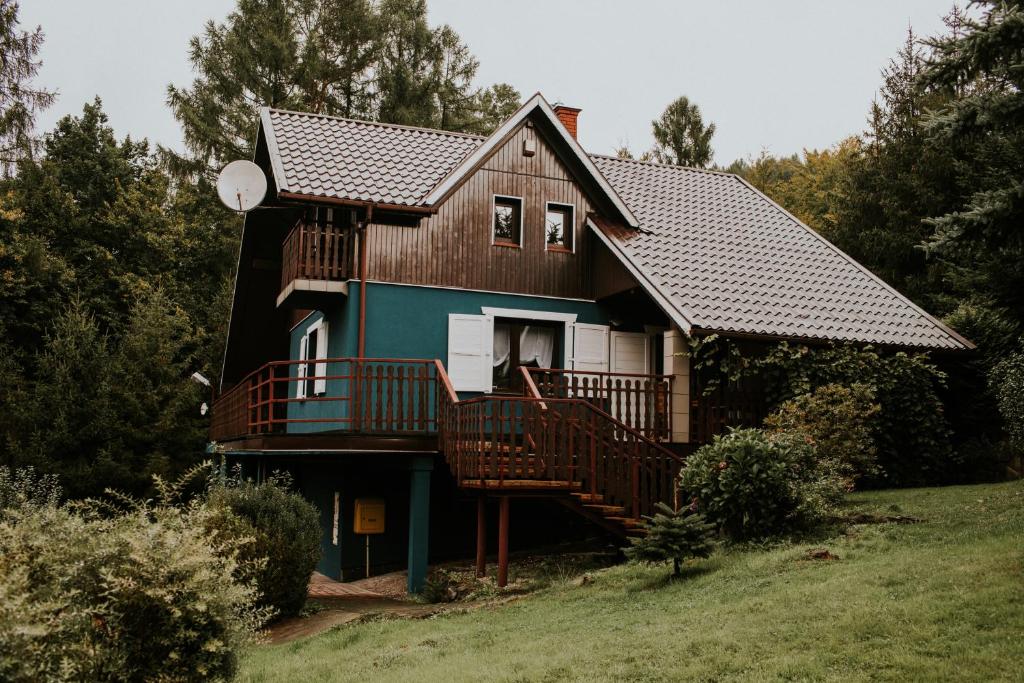 a house with a large deck and a balcony at Konkelówka- Dom z ogrodem i sauną, Góra Żar i jezioro in Międzybrodzie Żywieckie