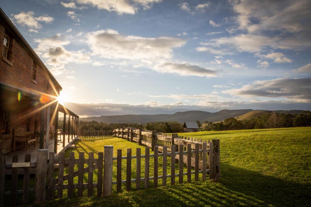 a fence next to a barn with a view of a field at The Barracks, Tocal in Paterson