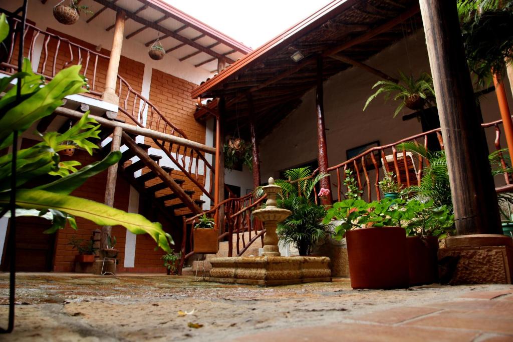 un edificio con una escalera y plantas delante de él en Casa Aparicio Lopez, en Barichara