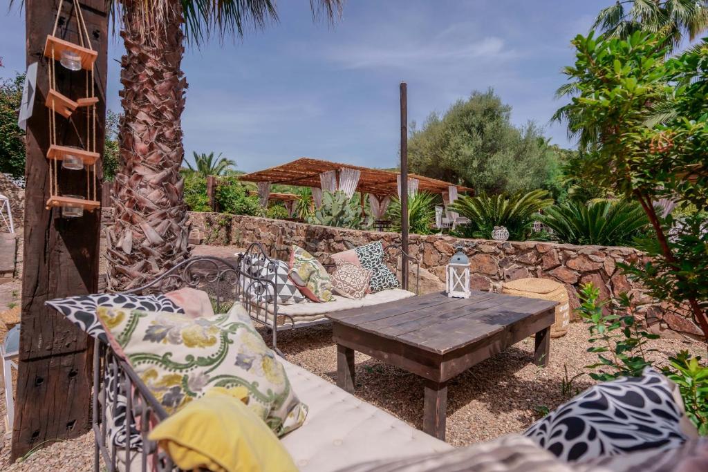 a patio with a wooden table and chairs at Il Monastero in Geremèas