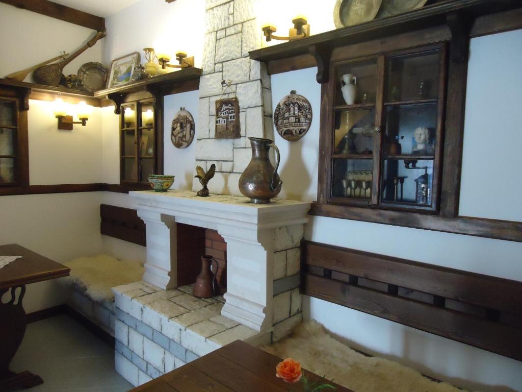 a living room with a fireplace in a house at Hotel Klea in Berat