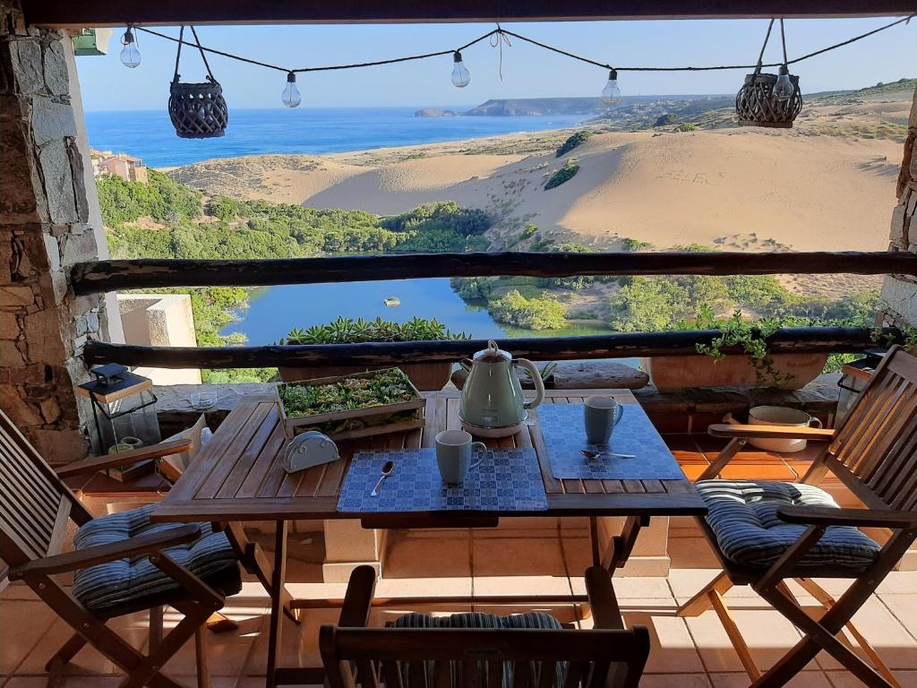 a table with a teapot on top of a balcony at Casa Ester in Torre Dei Corsari