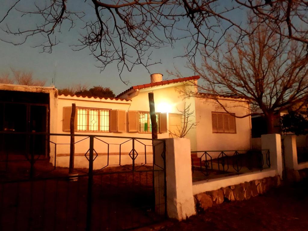a house with a light on the front of it at Urquiza61 in Capilla del Monte