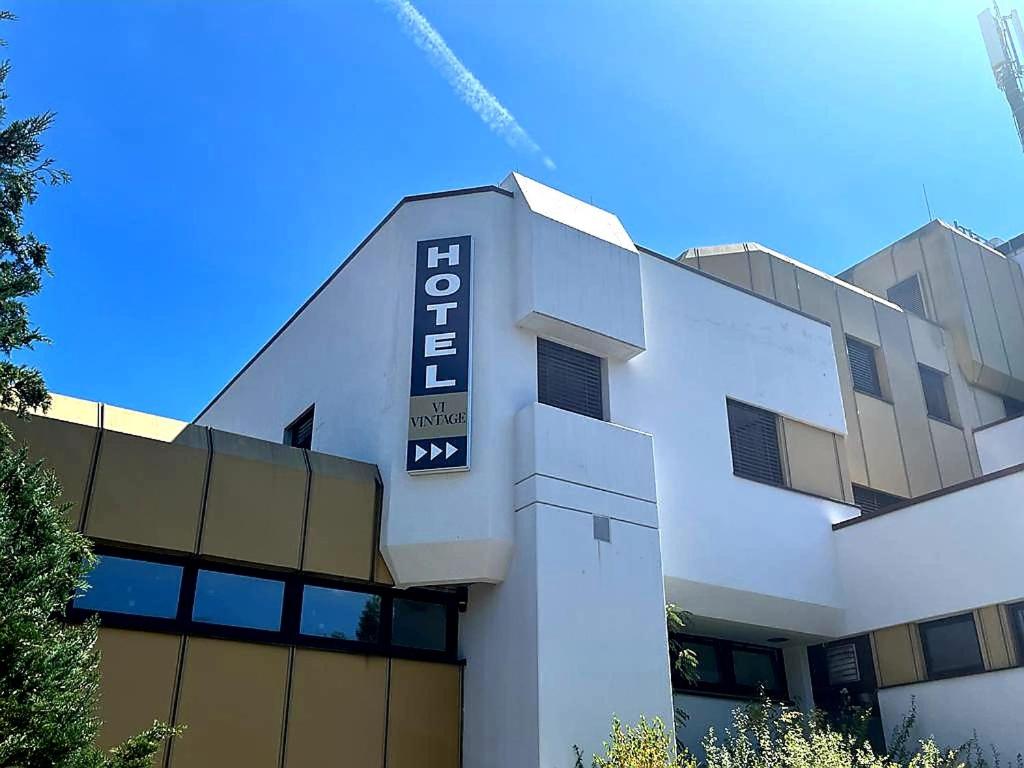 a building with a sign on the side of it at Hotel Vi Vintage S-Weilimdorf in Stuttgart-Weilimdorf