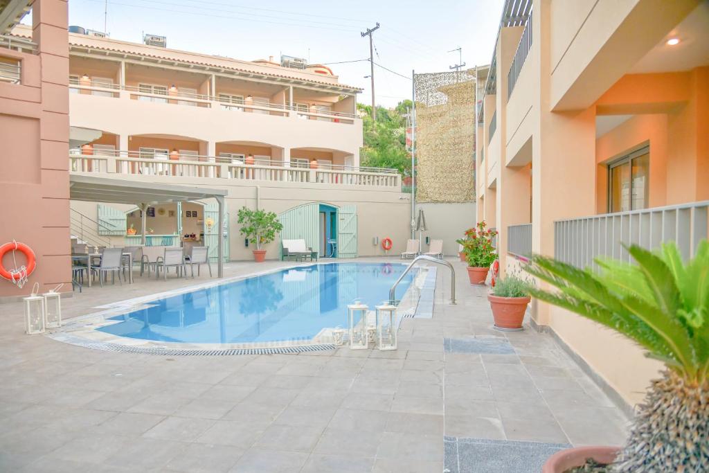 a swimming pool in the middle of a building at Anatoli Apartments in Agia Pelagia