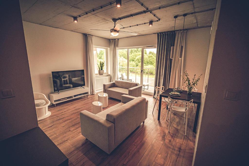 Televízia a/alebo spoločenská miestnosť v ubytovaní THE LOFT - Wiślana 28