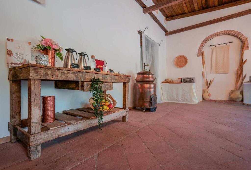 a room with a wooden table with a bowl of fruit on it at Il Monastero in Geremèas