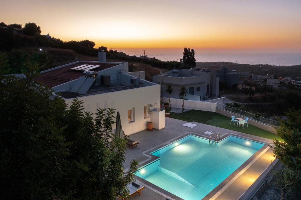 una vista aérea de una casa con piscina en Felix Villa with magic view and heated pool, en Ayía Paraskeví