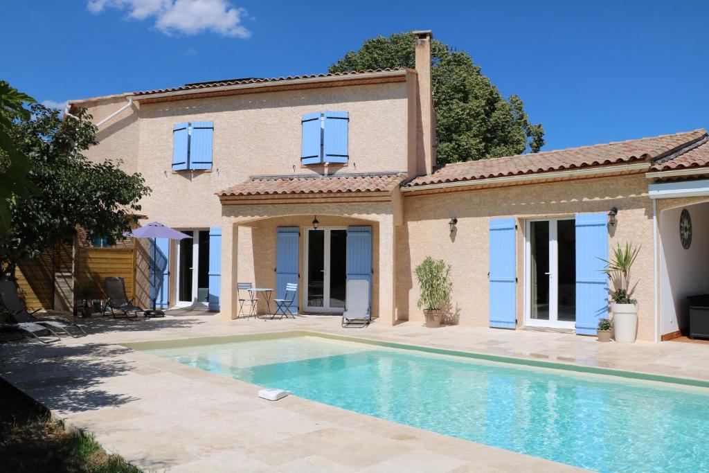 een villa met een zwembad voor een huis bij La Villa des Moulins in Calvisson